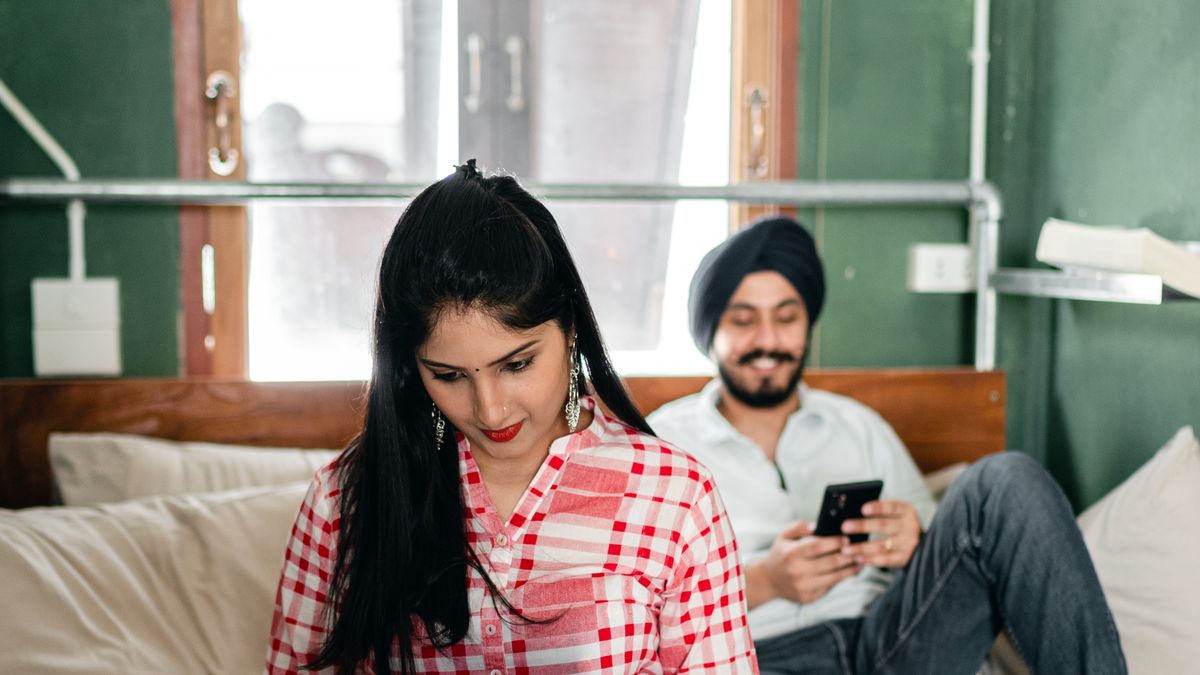 Indian couple relaxing on a bed, beginner guide to sex toys for men in India